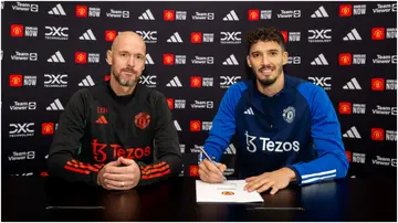 Altay Bayindir poses with Erik ten Hag after signing for Man United at Carrington Training Ground. Photo by Manchester United.