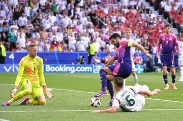 Germany's Ilkay Gundogan (C) fights for the ball with Hungary's Willi Orban (R) during his side's 2-0 win at Euro 2024