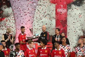 Bruno Fernandes and Erik Ten Hag of Manchester United holding the winners The Match Bangkok Century Cup trophy 