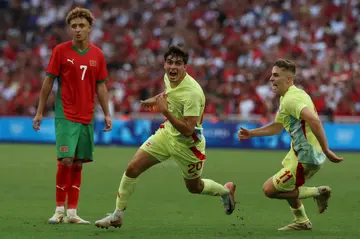 Juanlu Sanchez (C) celebrates with Fermin Lopez after scoring Spain's winning goal against Morocco in their Olympic men's football semi-final