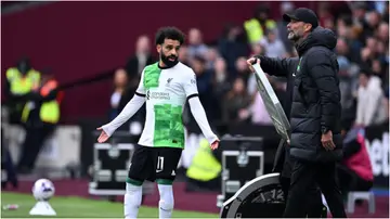 Mohamed Salah argues with Jurgen Klopp on the touchline ahead of a substitution during the Premier League match between West Ham United and Liverpool. Photo by Justin Setterfield.