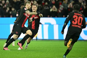 Record breaking: Bayer Leverkusen's Robert Andrich (left) celebrates scoring the winner on Friday
