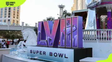 A Super Bowl LVIII logo and an oversized replica of the Vince Lombardi Trophy