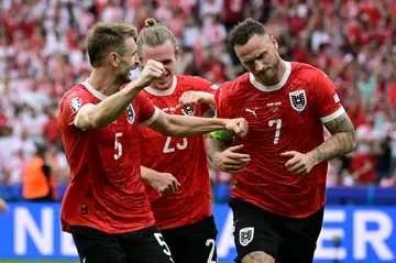 Marko Arnautovic (R) celebrates after scoring his penalty to wrap up Austria's win over Poland