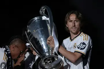 Luka Modric holding up the trophy after winning the Champions League for the sixth time