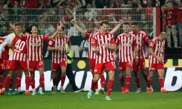 Union Berlin players celebrate after Danilho Doekhi's injury-time winner sent them top of the Bundesliga