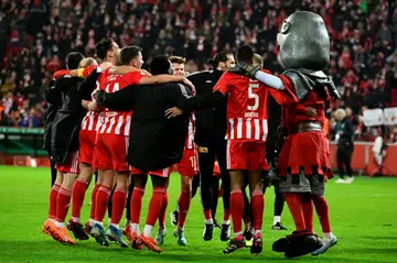 Union Berlin players, and the club's knight mascot, celebrate their cup victory
