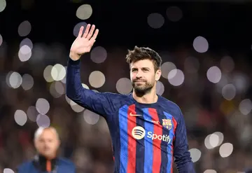 Gerard Pique waves to fans at Camp Nou after playing his last game there against Almeria
