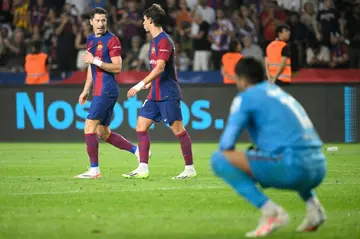 Joao Felix (C) celebrates with Robert Lewandowski (L) during Barcelona's rout of Real Betis
