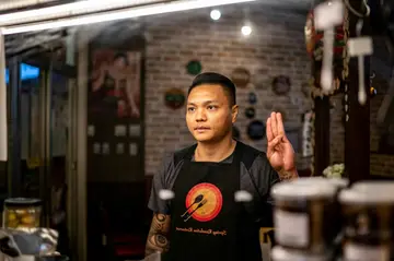 Refugee goalkeeper Pyae Lyan Aung flashed the three-fingered gesture, a popular protest symbol, as his team lined up to face Japan