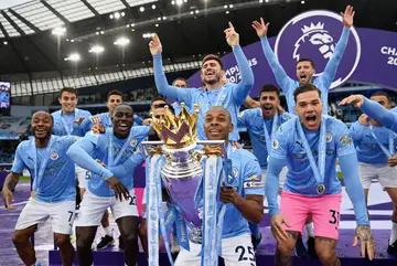 Fernandinho of Manchester City lifts the Premier League Trophy with his teammates
