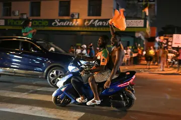Fans celebrate in the streets of Abidjan after Ivory Coast won through to the AFCON quarter-finals