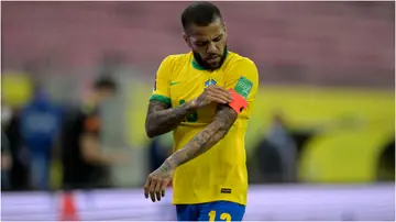 Dani Alves fixes his captain's armband during a match between Brazil and Peru. Photo by Pedro Vilela.