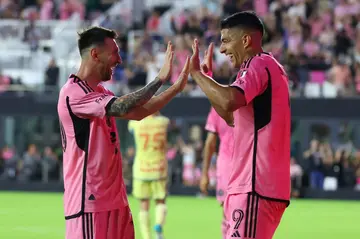 Luis Suarez celebrates with Lionel Messi after scoring his third goal against the New York Red Bulls in Saturday's 6-2 win.