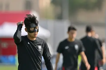 The masked Son Heung-min takes part in a World Cup training session