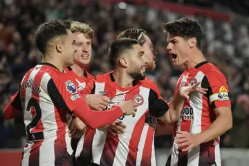 Brentford players celebrate after scoring during the Premier League match against Manchester City