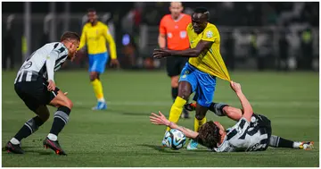 Al-Nassr's Sadio Mane is pulled down by an Al-Shabab defender during Saudi Pro League game.