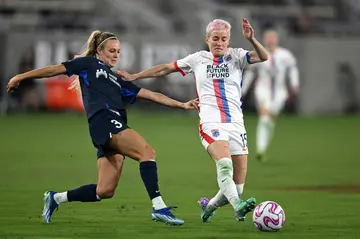 OL Reign midfielder Megan Rapinoe fights for the ball with San Diego Wave's Rachel Hill in the Reign's victory in their National Women's Soccer League semi-final