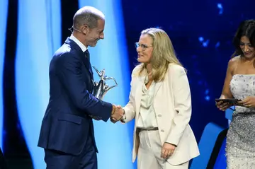 England manager Sarina Wiegman greets UEFA president Aleksander Ceferin after receiving the award for women's coach of the year