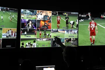 A live-stream producer points a screen in the production control room on a Kings League match day