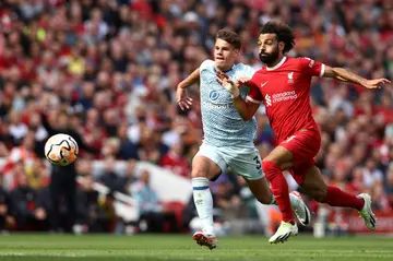 Liverpool forward Mohamed Salah (R) chases a loose ball with Bournemouth defender Milos Kerkez.