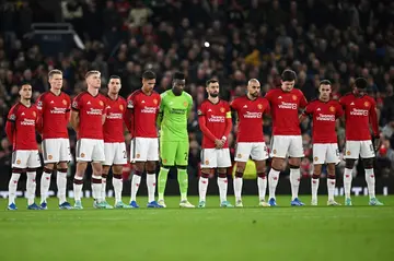 Manchester United's players observe a minute of silence to remember Bobby Charlton