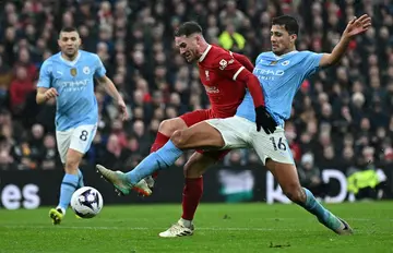 Manchester City midfielder Rodri (right) in action against Liverpool at Anfield