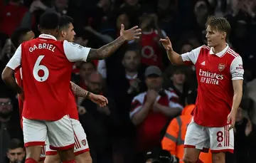 Arsenal midfielder Martin Odegaard (R) celebrates scoring against Chelsea
