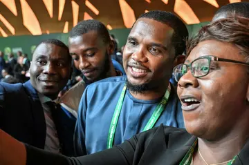 Cameroon Football Federation president and former star Samuel Eto'o (C) mingles with attendees at the  CAF Ordinary General Assembly in Abidjan on July 13, 2023.