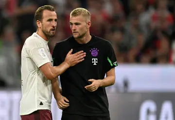 Bayern Munich's English forward Harry Kane (L) talks to Dutch defender Matthijs de Ligt during their side's 3-0 Super Cup loss to RB Leipzig