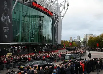 A hearse carrying the coffin of Bobby Charlton is driven past Old Trafford