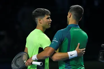 Novak Djokovic and Carlos Alcaraz embrace after playing an exhibition match in the Saudi capital on December 27
