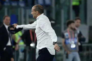 Juventus coach Massimiliano Allegri tosses away his tie after seeing red during his side's 1-0 victory against Atalanta in the Italian Cup final