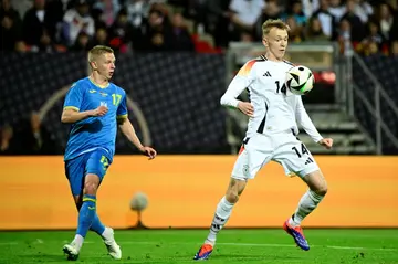 Maximilian Beier (r), watched by Ukraine's Oleksandr Zinchenko,  impressed on his Germany debut