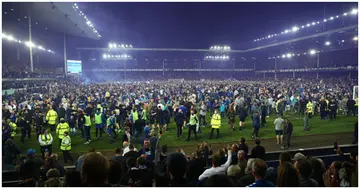 Everton fans celebrate on the pitch following the Premier League match between Everton and Crystal Palace at Goodison Park. Photo by Chris Brunskill.