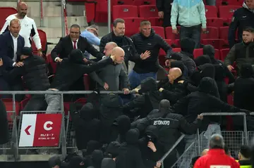 Black-hooded AZ Alkmaar fans tried to storm the area reserved for family and friends of West Ham players and management