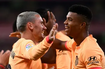 Atletico Madrid's French forward Antoine Griezmann celebrates with Atletico Madrid's Mozambican defender Reinildo Mandava (R)