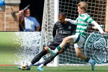 Celtic's Japanese forward Kyogo Furuhashi, right, pressures Chelsea's Spanish goalkeeper Robert Sanchez during a pre-season club friendly football match won 4-1 by Celtic at South Bend, Indiana