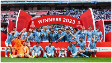 Manchester City players celebrate with the trophy during the Emirates FA Cup Final match between Manchester City and Manchester United at Wembley Stadium. Photo by Marc Atkins.