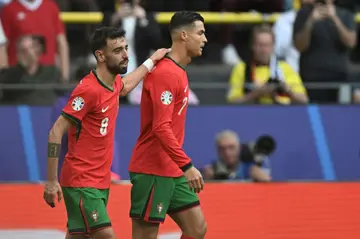 Bruno Fernandes and Cristiano Ronaldo celebrate together after the duo combined for Portugal's third goal in their 3-0 win over Turkey at Euro 2024