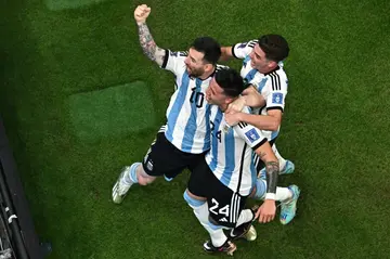 Argentina midfielder Enzo Fernandez celebrates scoring his team's second goal with Lionel Messi (left) and Julian Alvarez during the 2-0 win over Mexico