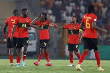 Mabululu, Angola's number 19, celebrates scoring his team's equaliser against Algeria from the penalty spot