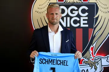 Danish goalkeeper Kasper Schmeichel poses with his jersey after signing for French League 1 football club Nice