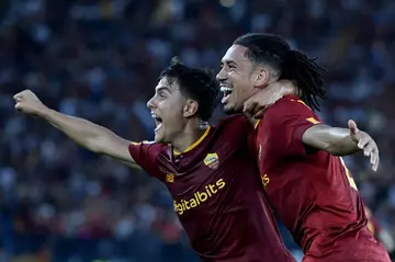 Chris Smalling (right) celebrates his goal with Roma team-mate Paulo Dybala