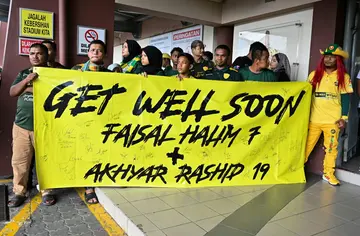 Fans hold a banner supporting injured footballers before the start of the Malaysia Super League match between Polis DiRaja Malaysia (PDRM) FC and Kedah on May 11, 2024