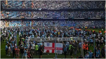 Manchester City fans invade the pitch as they celebrate winning the title after their Premier League match against Chelsea at the Etihad Stadium. Photo by Oli Scarff.