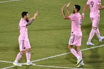Lionel Messi and Sergio Busquets celebrate a goal for Inter Miami. The players are both nominated for awards in the MLS this year.