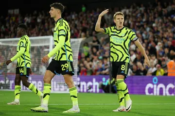 Arsenal's Martin Odegaard (R) celebrates scoring against Crystal Palace