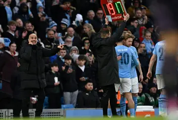 Manchester City manager Pep Guardiola (L) brought on Kevin De Bruyne (R) as a second-half substitute in a 5-0 FA Cup win over Huddersfield