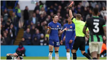 Chelsea's Conor Gallagher is shown a red card by the reeree during the Premier League match against Brighton at Stamford Bridge on December 3, 2023.